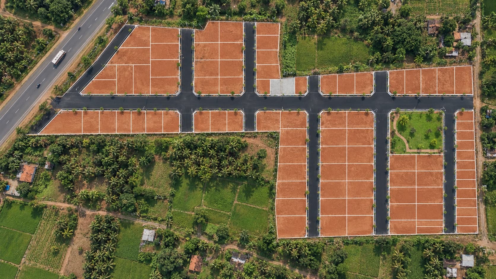 Black-top road at Vijaya Gardens with the Western Ghats behind